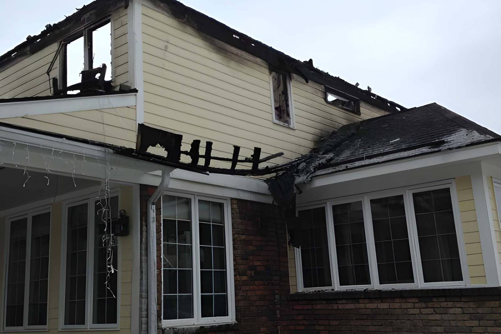 Exterior shot of a severely fire-damaged home
